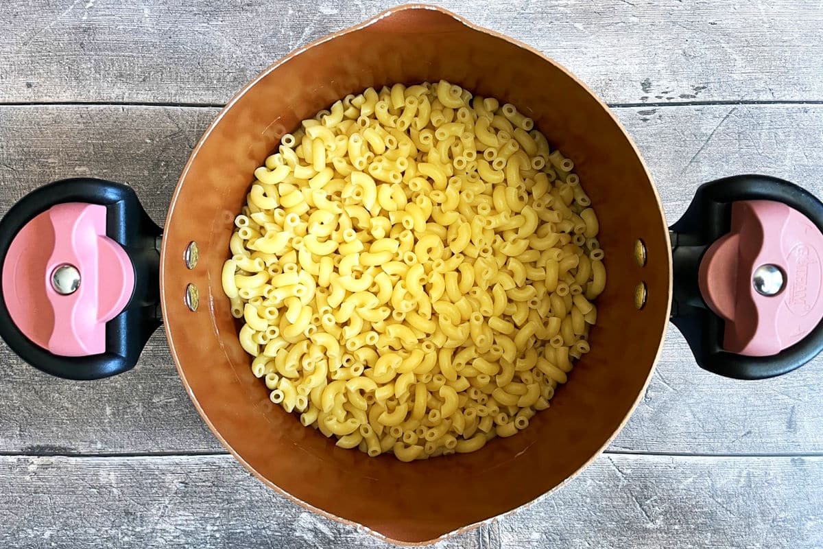 Cooked macaroni noodles in pot.