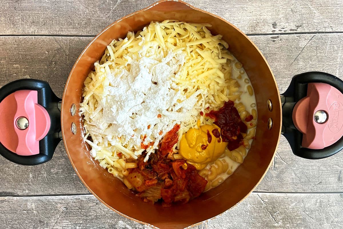 Macaroni, cheese and kimchi in pot.