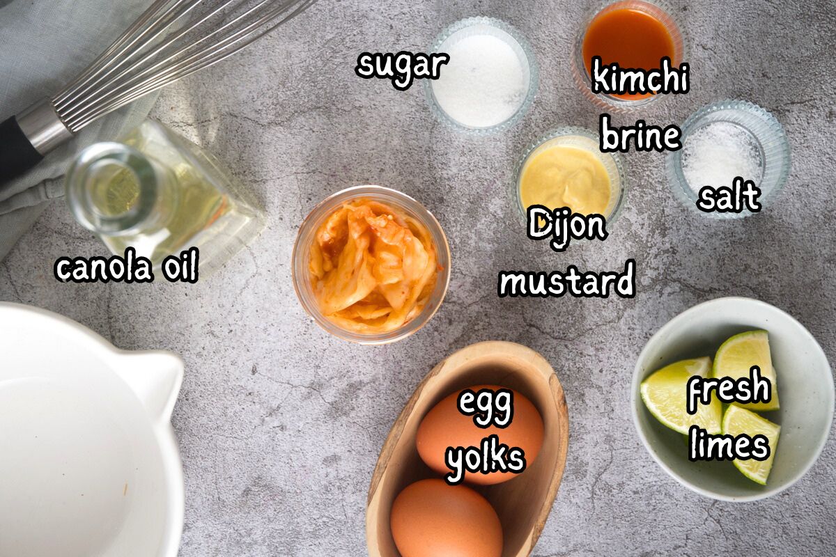 Kimchi mayo from scratch ingredients prepped and labeled on grey background.