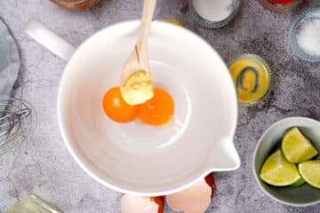 Egg yolks and mustard in bowl.