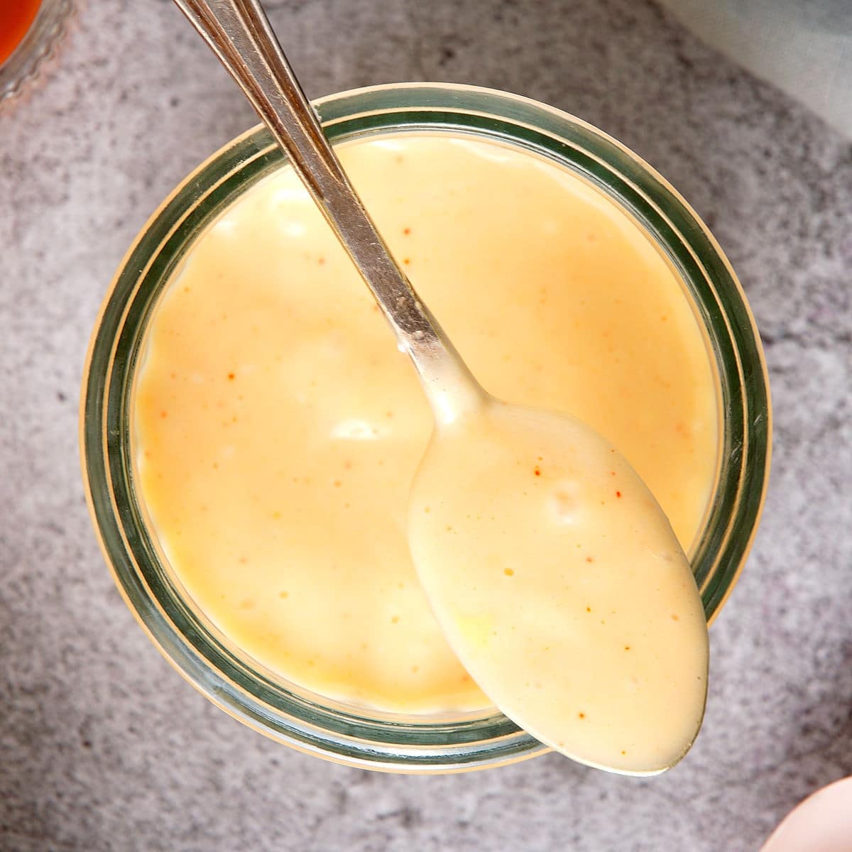 Kimchi mayo in jar and on spoon.