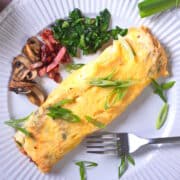 Kimchi omelette on plate with fork.