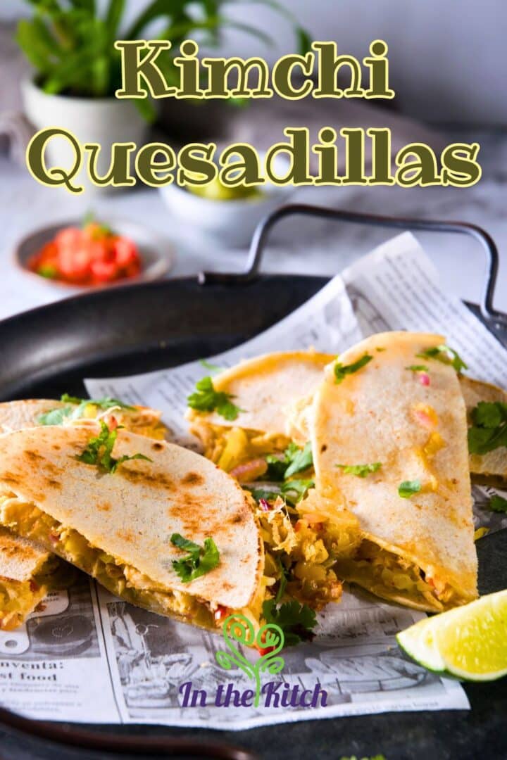 Kimchi quesadillas on serving tray with text overlay that says 'kimchi quesadillas'.