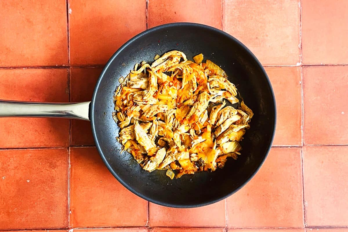 Kimchi chicken filling for quesadillas in pan.