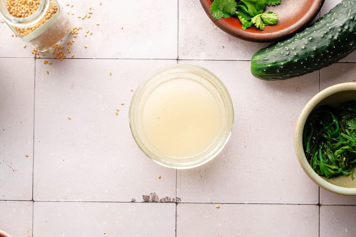 Brine in jar on tiled background.