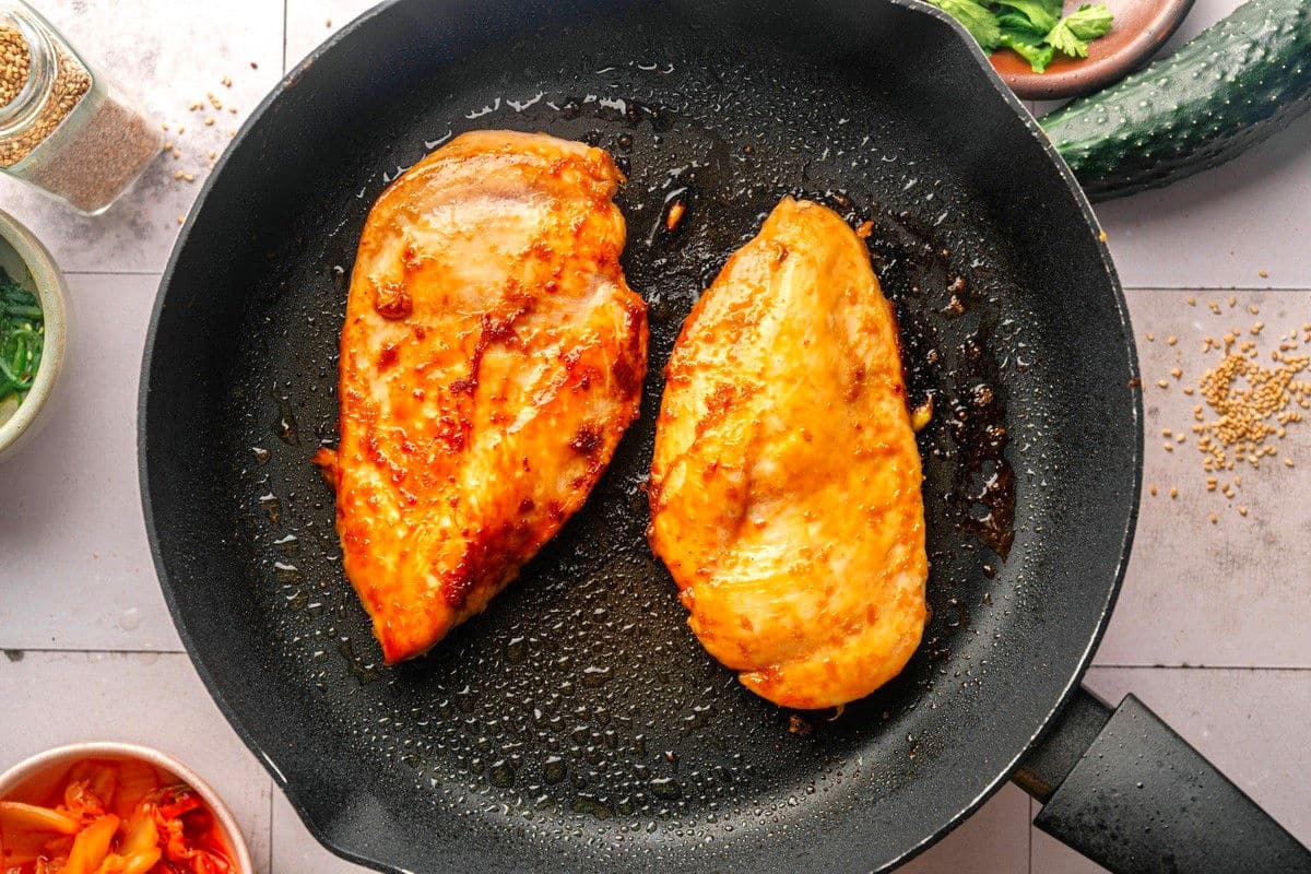 Chicken breasts in frying pan.