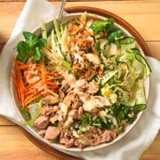 Kimchi salad in salad bowl on wooden background.