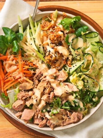 Kimchi salad in salad bowl on wooden background.
