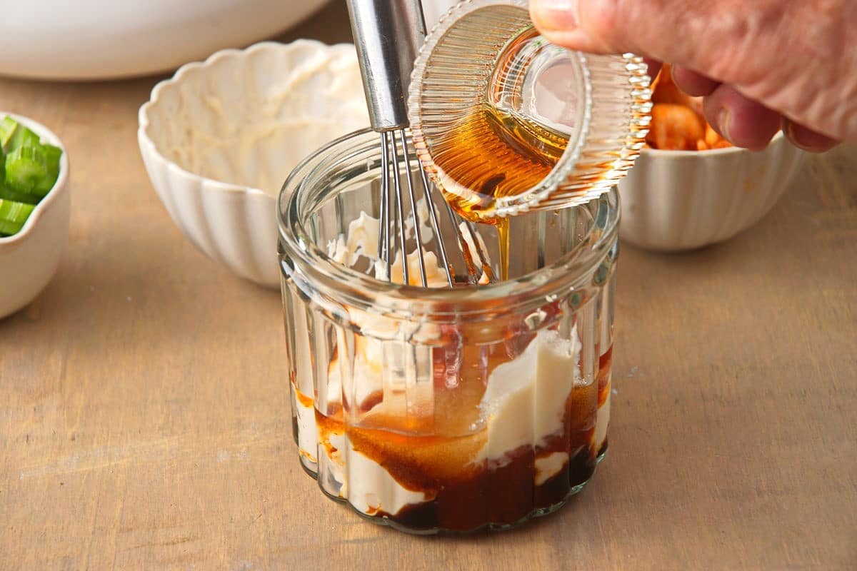 Kimchi salad dressing in jar with whisk.
