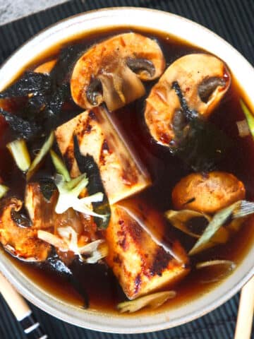 Kimchi tofu vegan soup in white bowl.