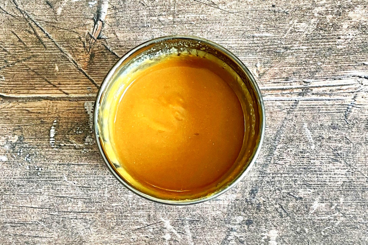 Miso paste with hot water in small bowl.