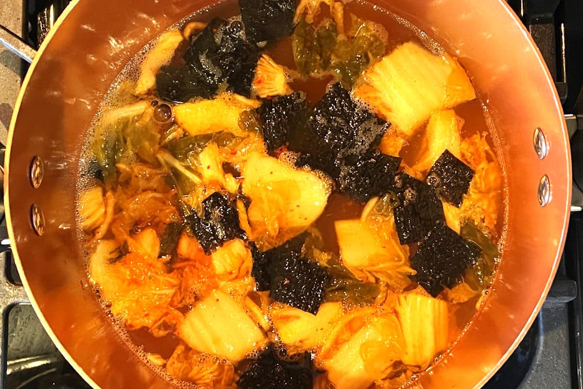 Kimchi tofu soup simmering in pot.