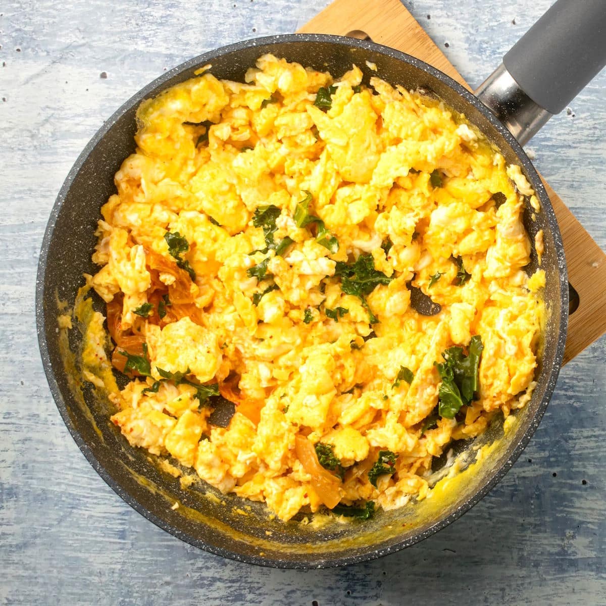Korean kimchi scrambled eggs in pan.