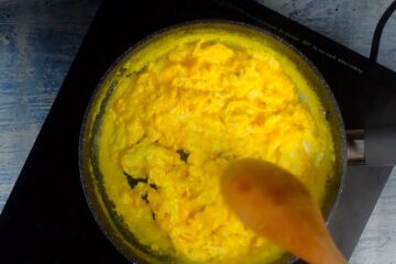 Scrambled eggs in pan.