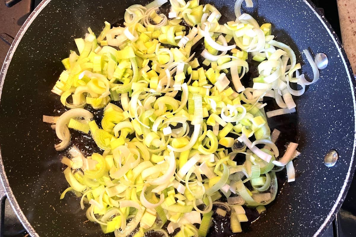Sliced leeks in frying pan.