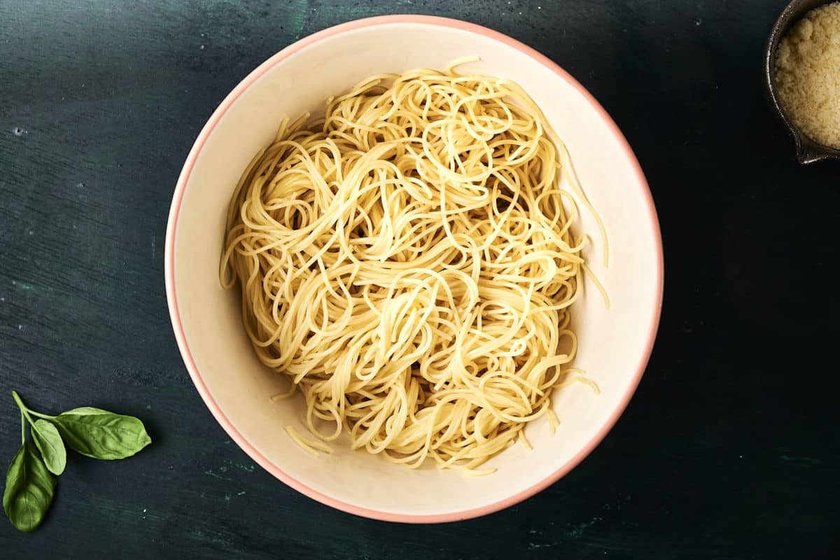 Bowl of cooked angel hair noodles.