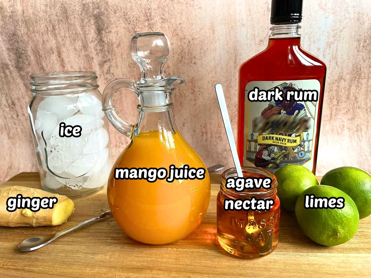 Mango ginger cocktail ingredients on wooden board - labeled.