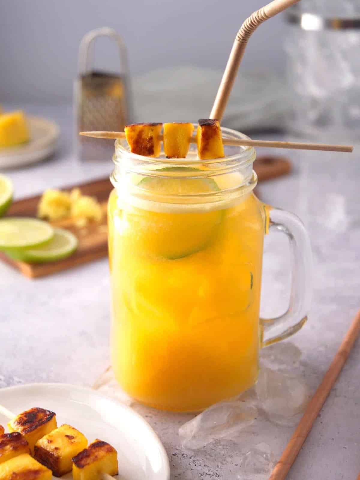 Mango ginger cocktail in ice-filled glass.
