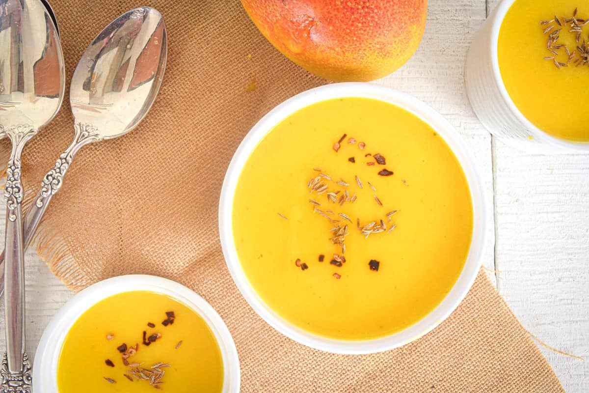 Mango soup in white bowls.