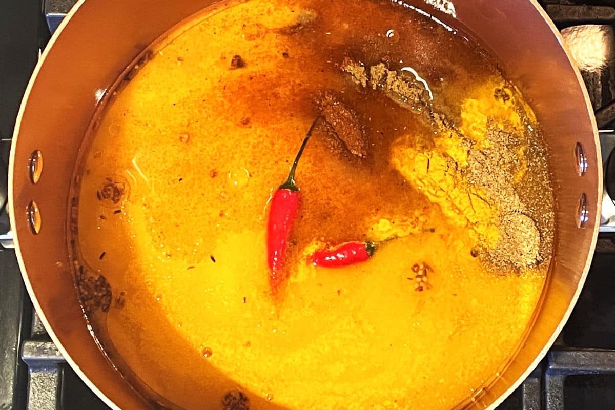 Mango soup ingredients in pot.