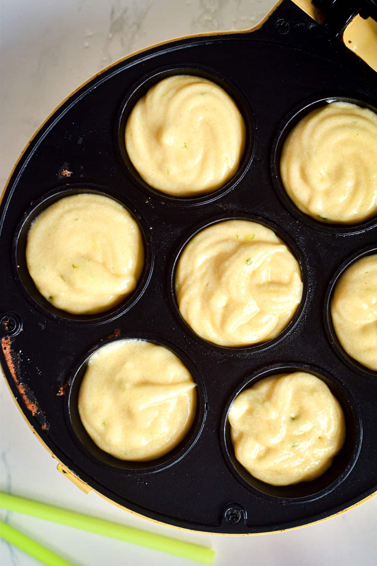 Margarita cake pop batter in cake pop maker holes.