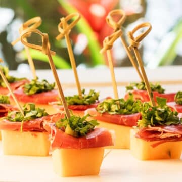 Melon prosciutto skewers with toothpicks.
