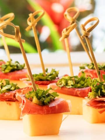 Melon prosciutto skewers with toothpicks.
