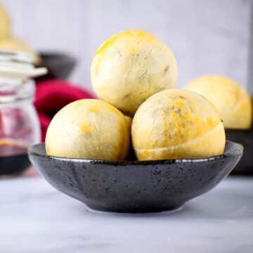 Mini Chinese pork buns in small black dish.