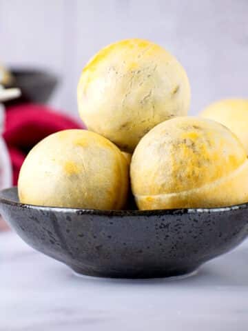 Mini Chinese pork buns in small black dish.