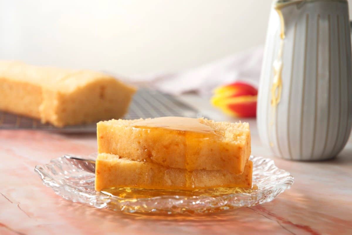 Pancake bread stacked on plate with pancake syrup.
