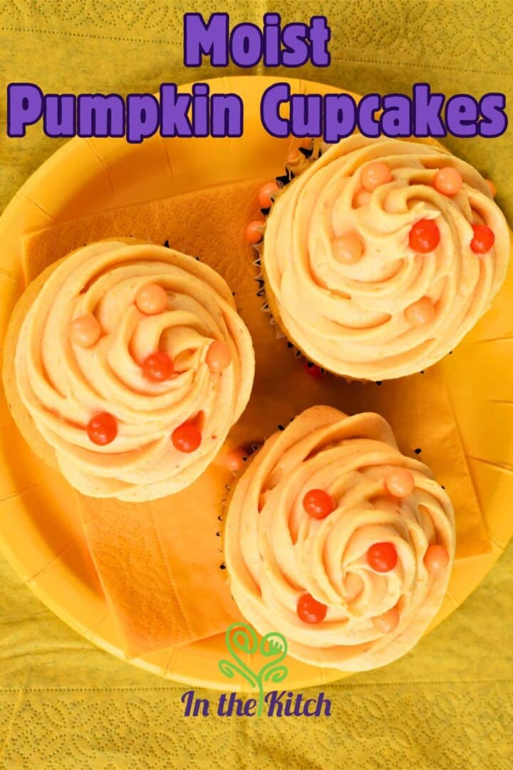 Pumpkin cupcakes on plate with text overlay that says 'moist pumpkin cupcakes'.