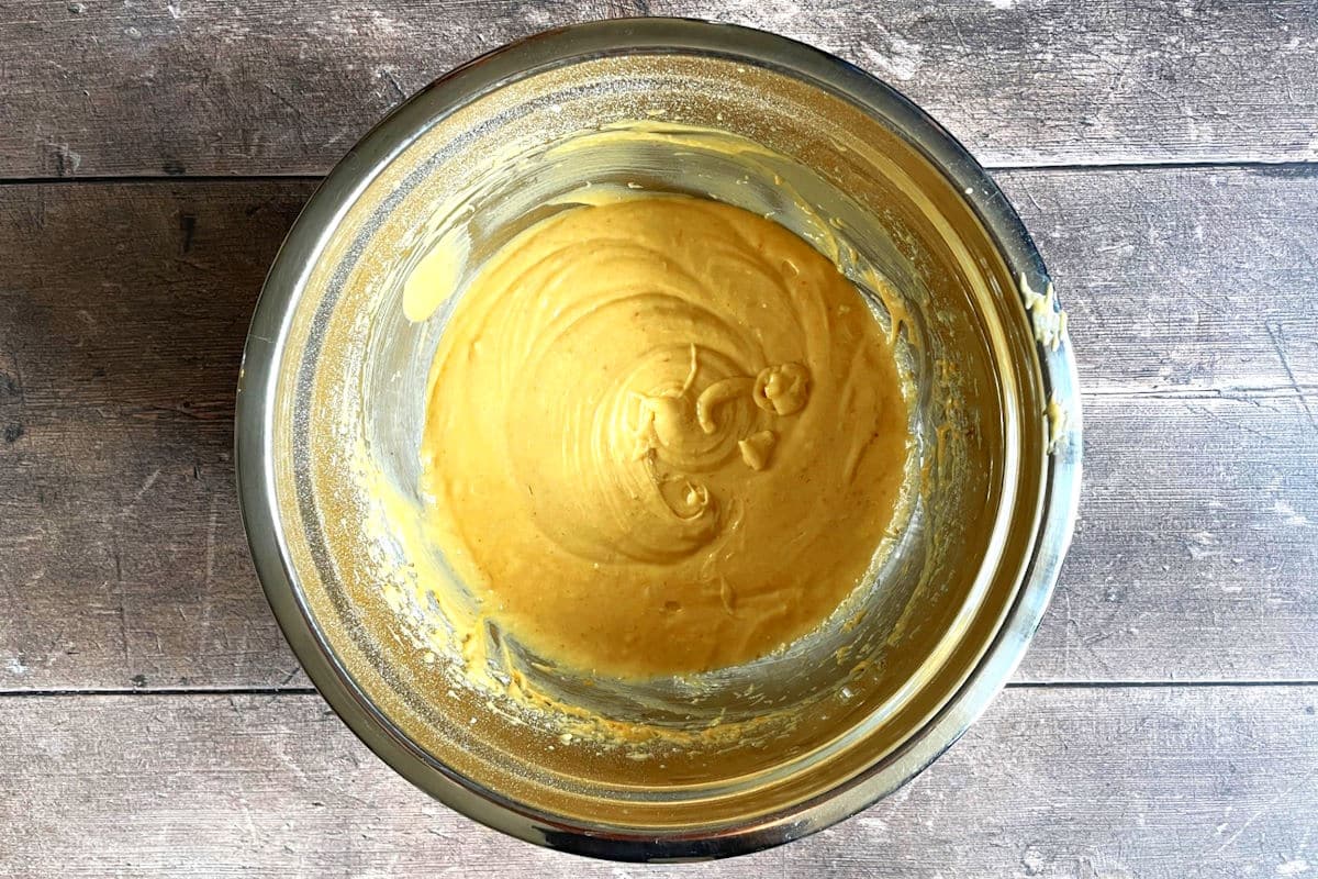 Pumpkin cupcake batter in a bowl.