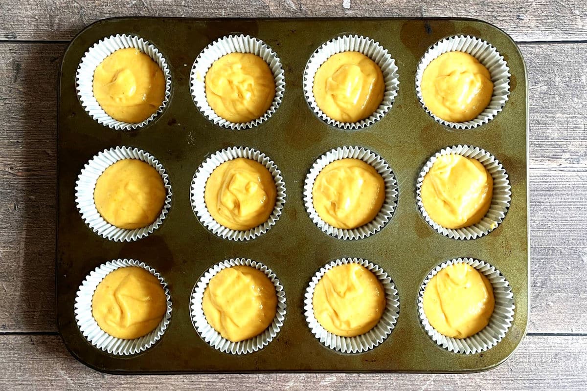 Pumpkin cupcake batter in cupcake tray.