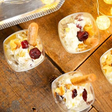 Goat cheese shots with mini breadsticks and Christmas lights on the side.