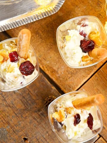 Goat cheese shots with mini breadsticks and Christmas lights on the side.