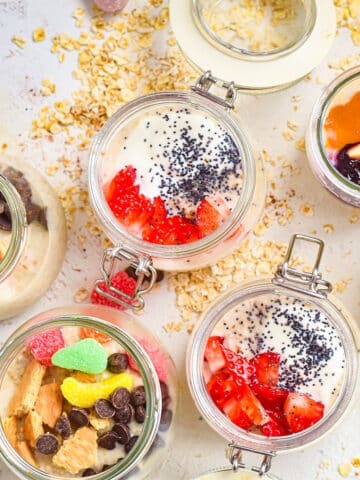 Oatmeal porridge with toppings in jars.