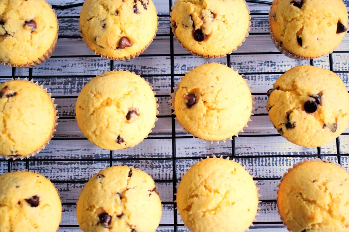 Orange chocolate chip muffins on baking rack.