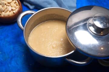 Ground almonds in sugar water in pot with lid.