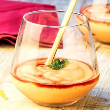Papaya cream with cassis in wine glass.