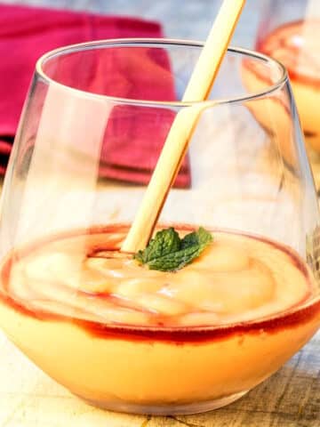 Papaya cream with cassis in wine glass.