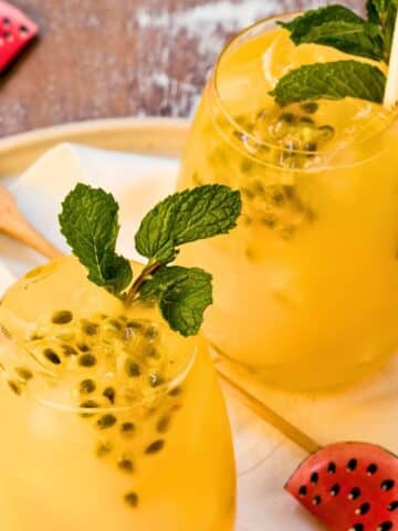 Passion fruit mojitos with fresh mint in glasses.