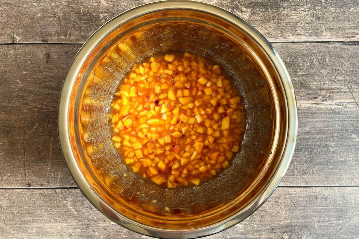 Diced peach jam mixture in bowl.