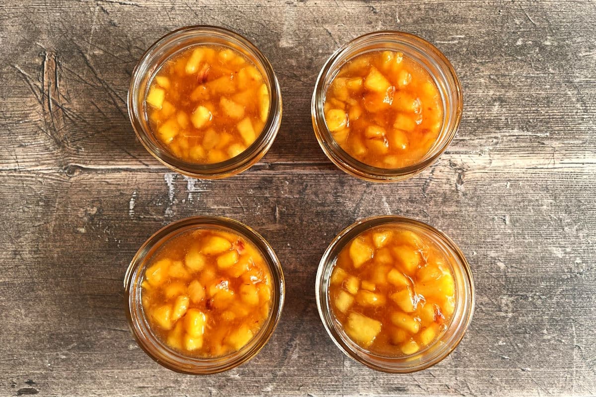Peach freezer jam in jam jars.