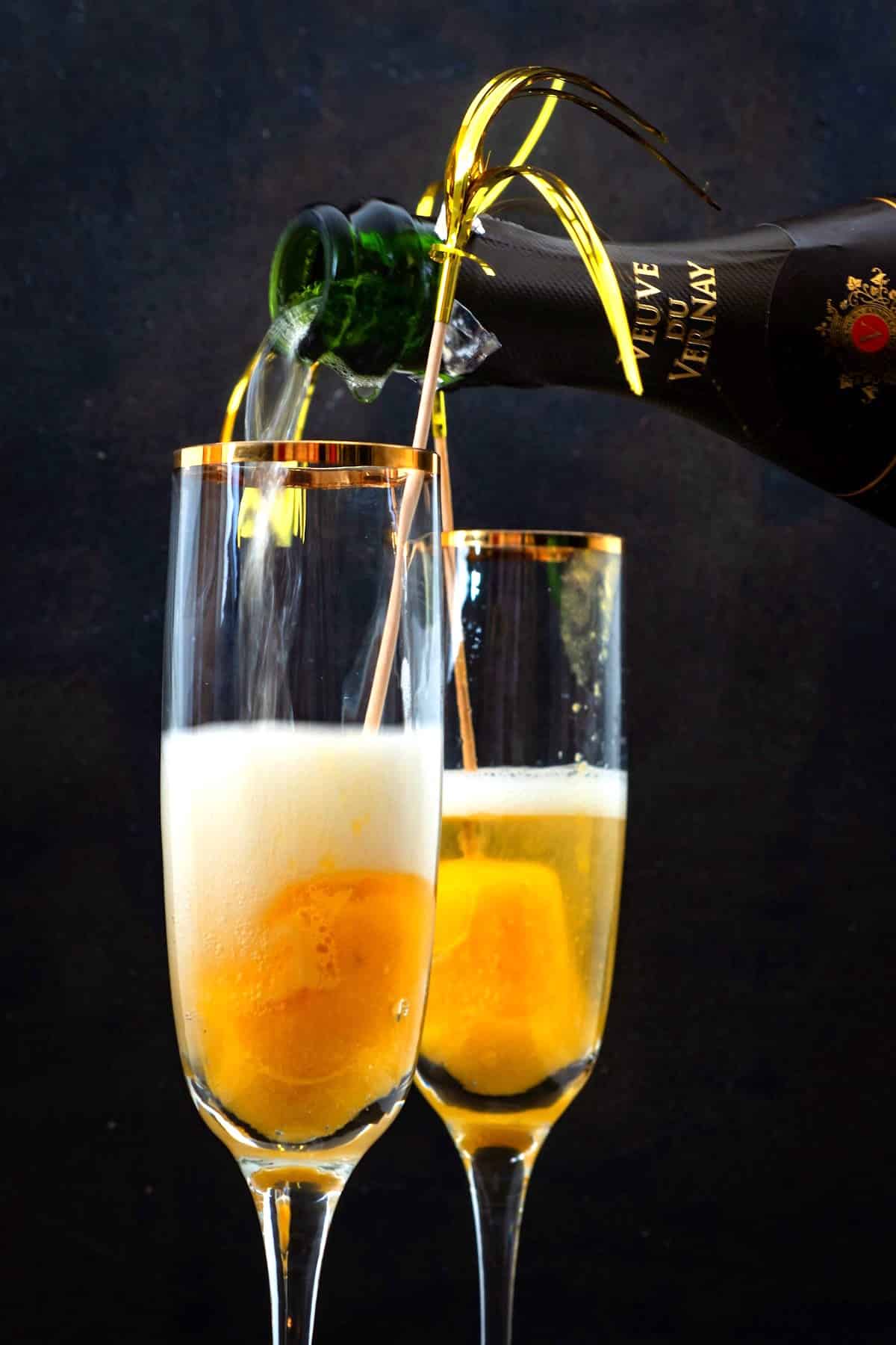 Champagne flutes filled with peach bellini.