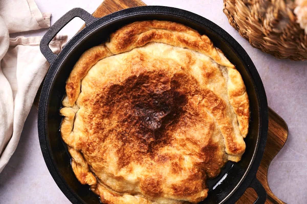 Baked peach tarte tatin in cast iron skillet.