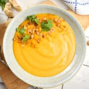Peanut butter soup in a speckled bowl.