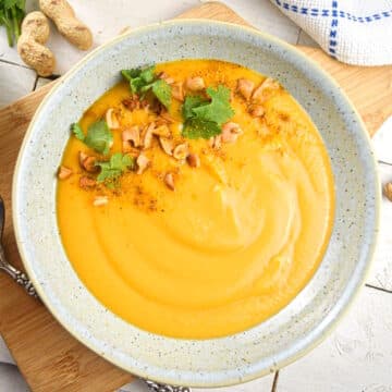 Peanut butter soup in a speckled bowl.