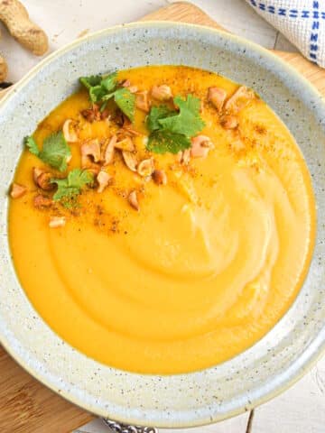 Peanut butter soup in a speckled bowl.