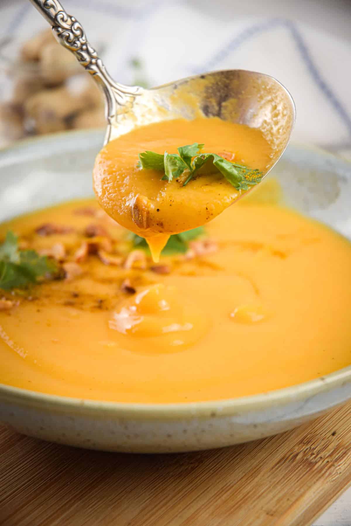 Peanut butter soup in a ladle and bowl.