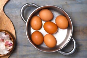Brown eggs in saucepan.